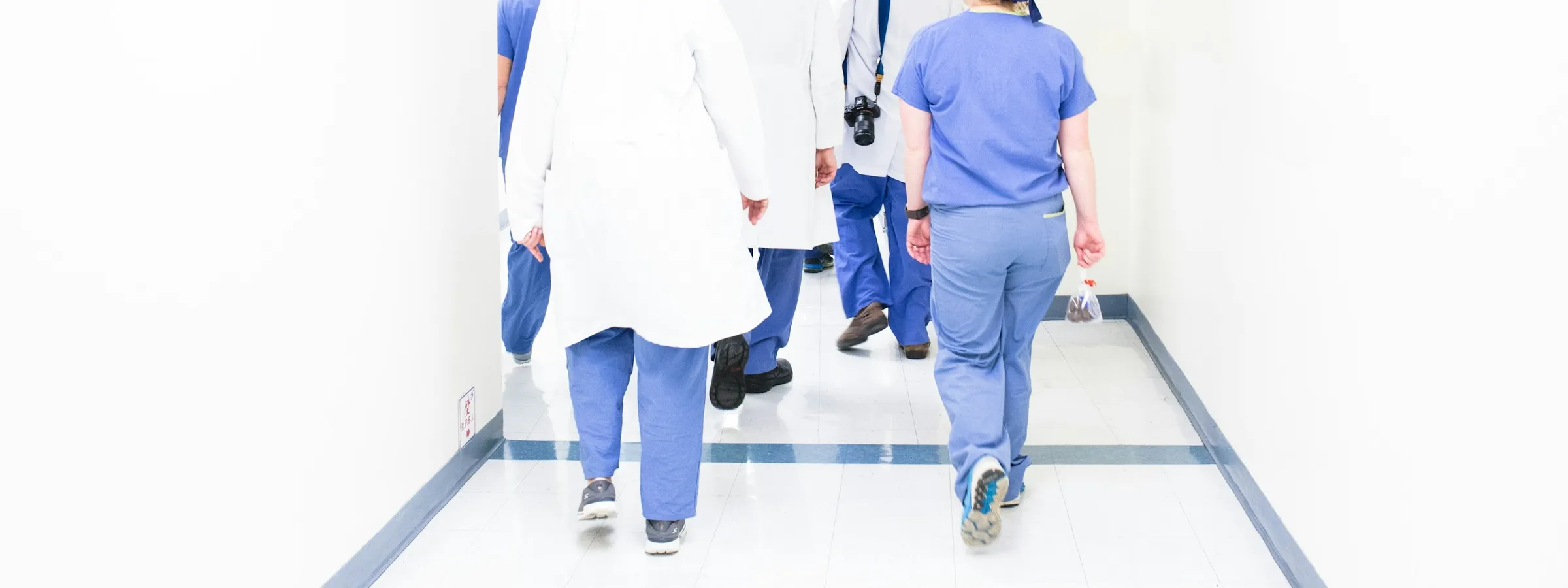 Clinical staff walking together through a hospital corridor