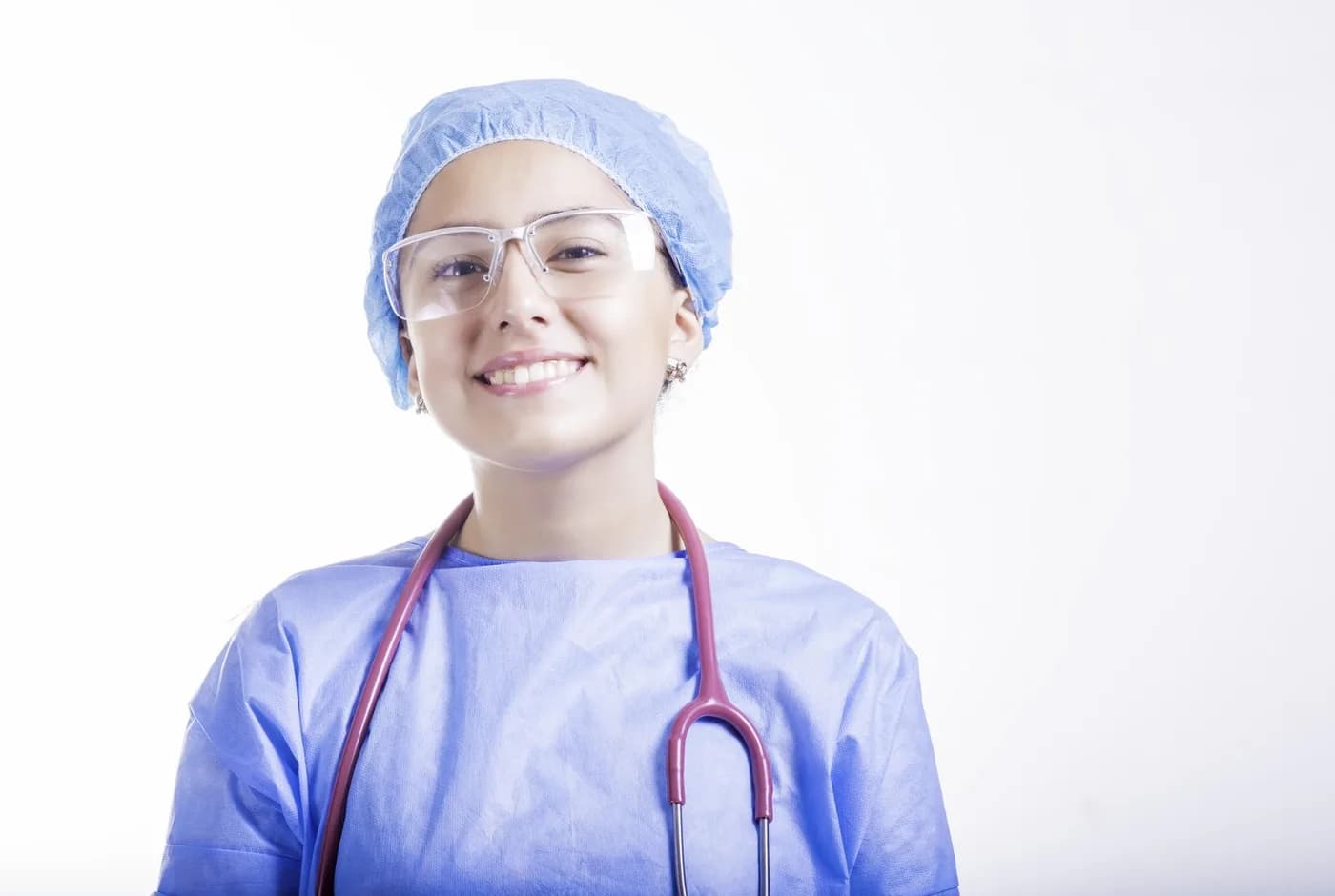 A theatre nurse in surgical cap, gown and eye protection