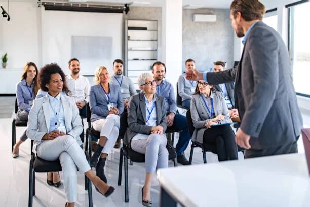 A speaker addressing seated professionals at a networking session